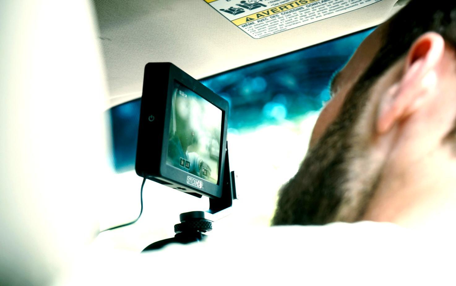 Professional video editing workspace with multiple monitors showing timeline and color correction tools