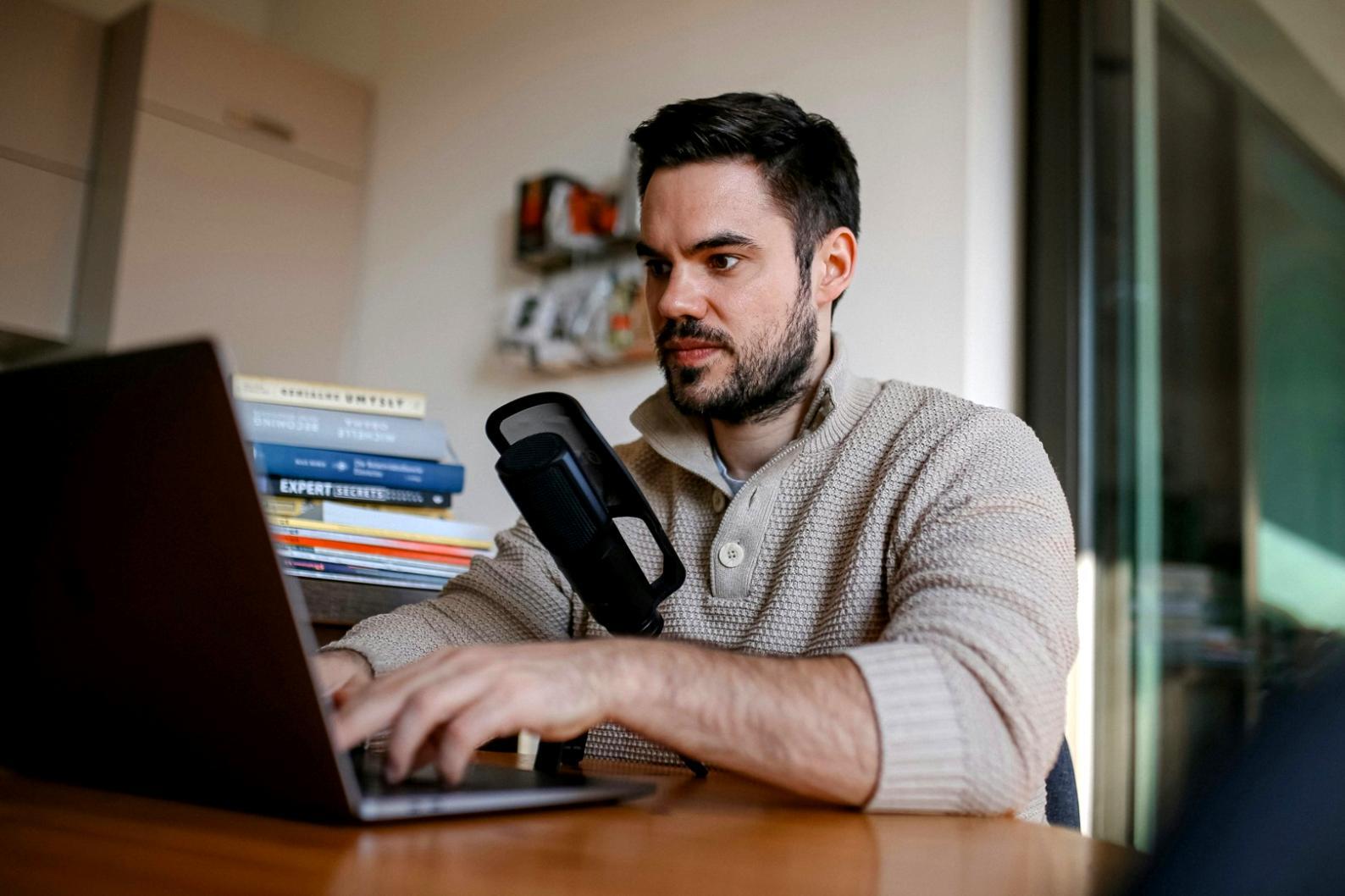 Student working intensively on video editing project with instructor providing guidance over complex timeline sequence
